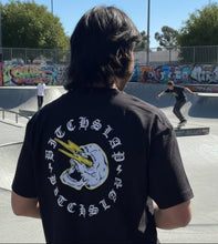 Load image into Gallery viewer, Person wearing a Bitchslap t-shirt in skate park
