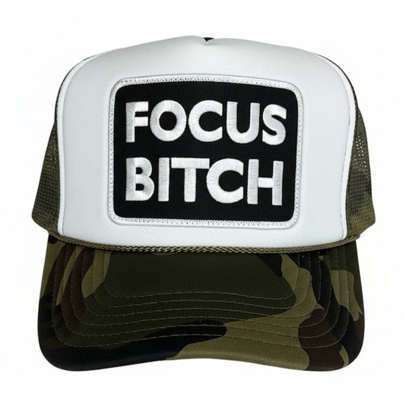 A camouflage trucker hat with 'FOCUS BITCH' embroidered on the front.