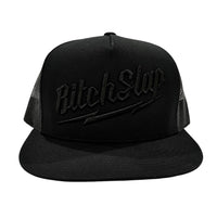 A black flat brim snapback trucker hat with 3D embroidery of 'BitchSlap' Big Bolt on the front.