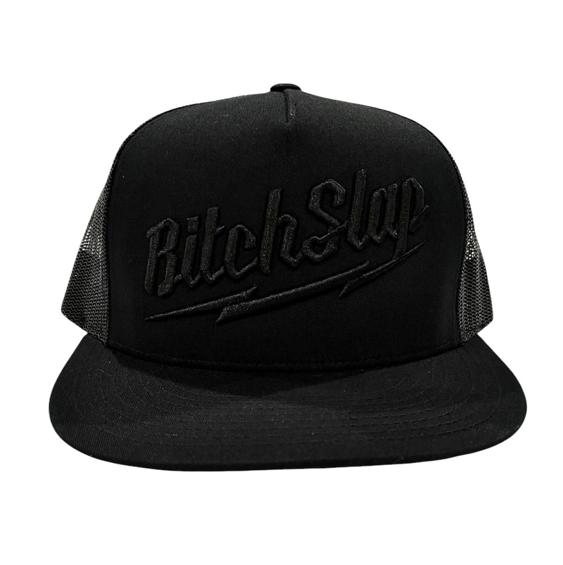 A black flat brim snapback trucker hat with 3D embroidery of 'BitchSlap' Big Bolt on the front.